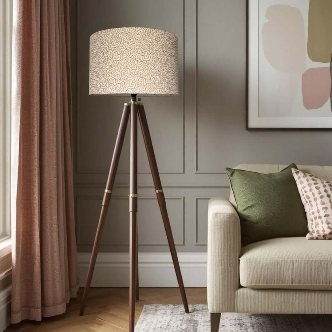 Triangular floor lamp in a living room setting with Ian Sanderson Elney Drum lampshade in Shrimp.