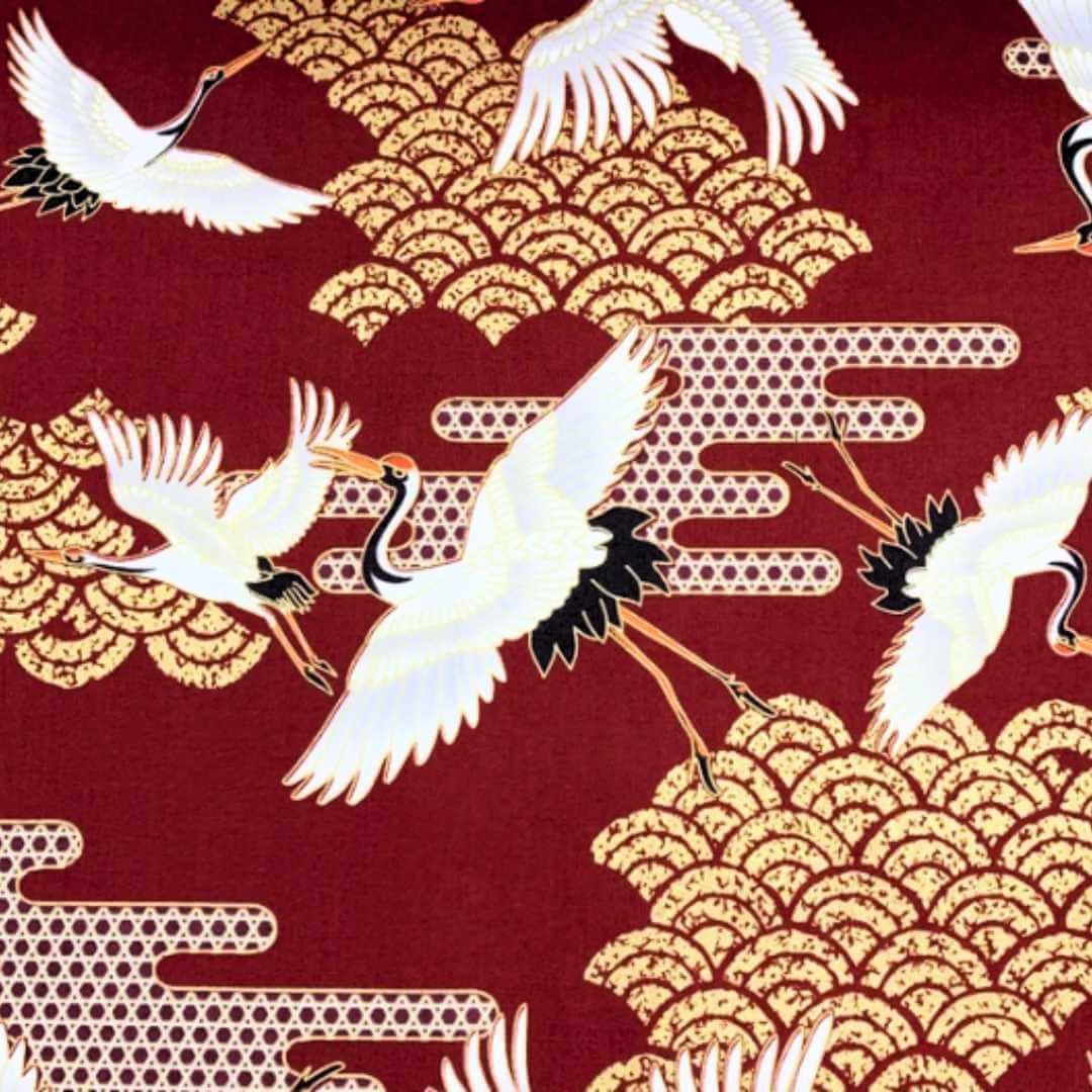Red and gold fabric with japanese cranes and art deco style clouds 