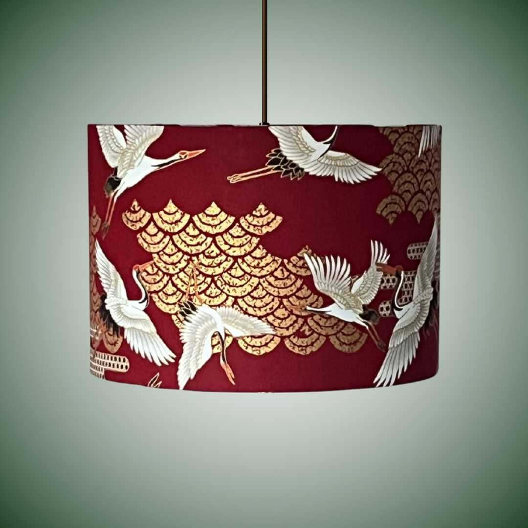 Red drum lampshade with japanese cranes and art deco style clouds on a pendant