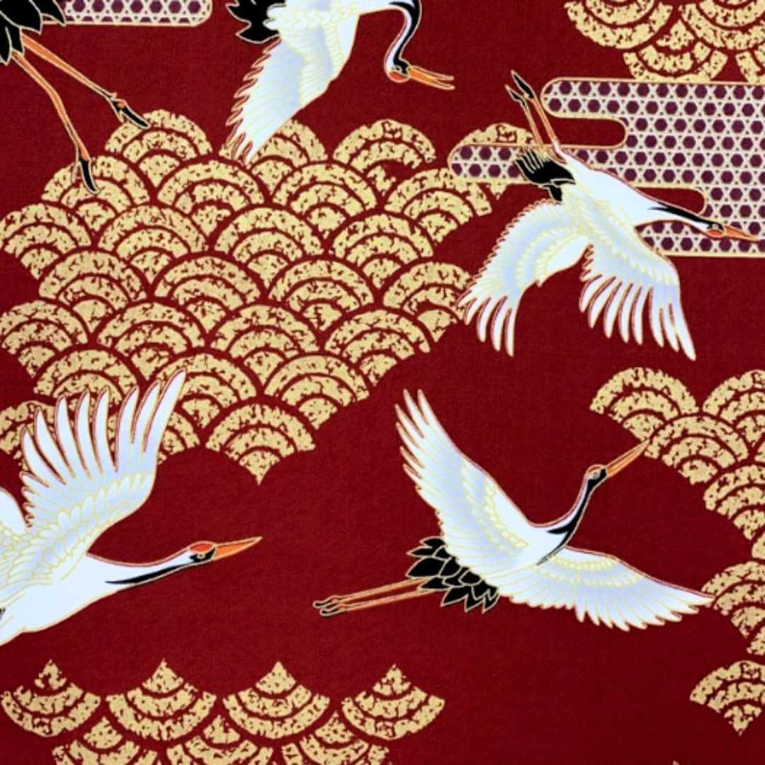 Red and gold fabric with japanese cranes and art deco style clouds 