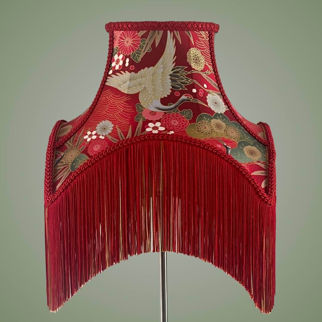 bowed empire lampshade with cut outs in red japanese fabric and fringe front view