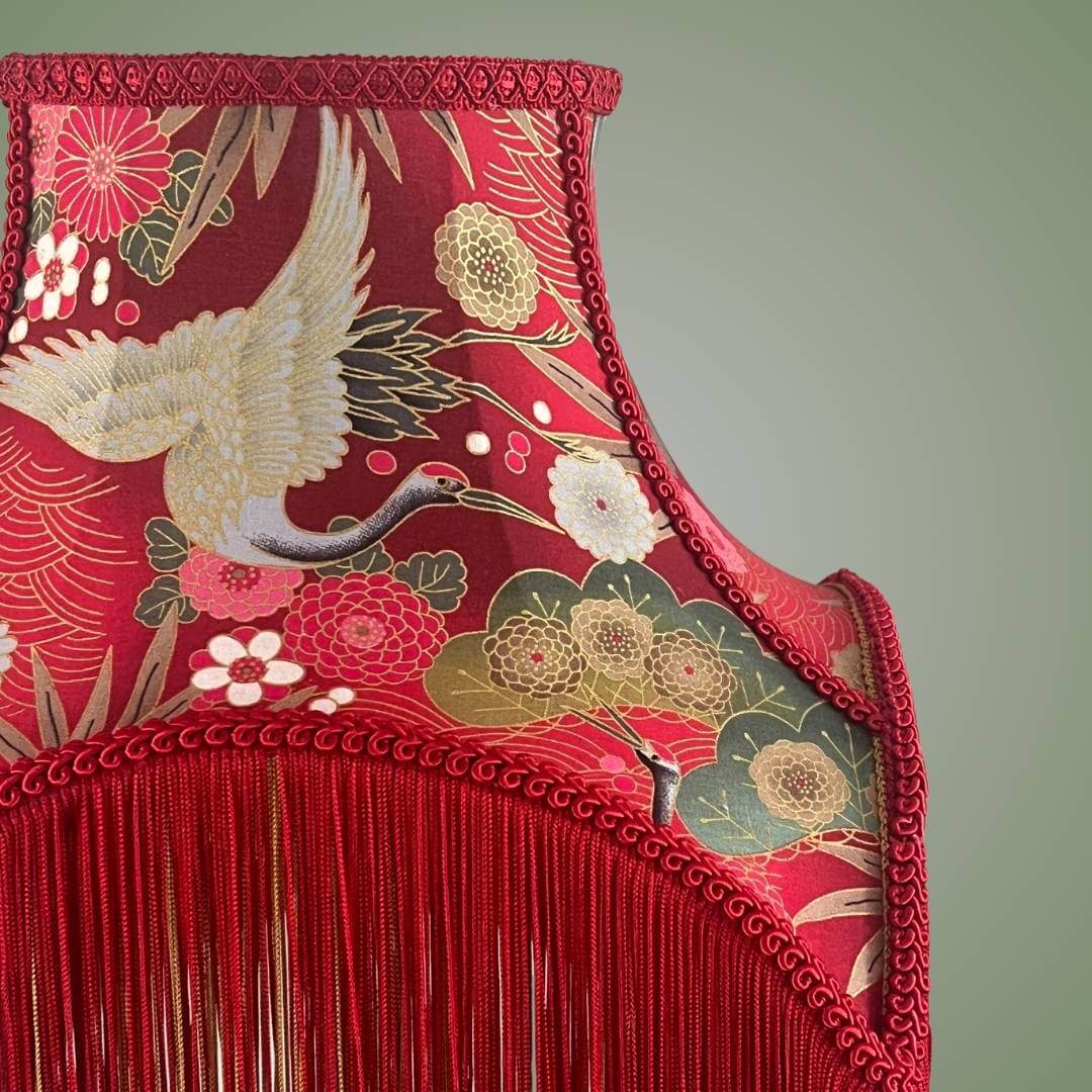 bowed empire lampshade with cut outs in red japanese fabric and fringe showing details