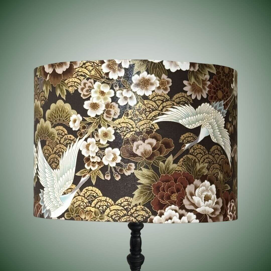 Japanese cranes and florals drum lampshade with metallic accents on a black lamp base