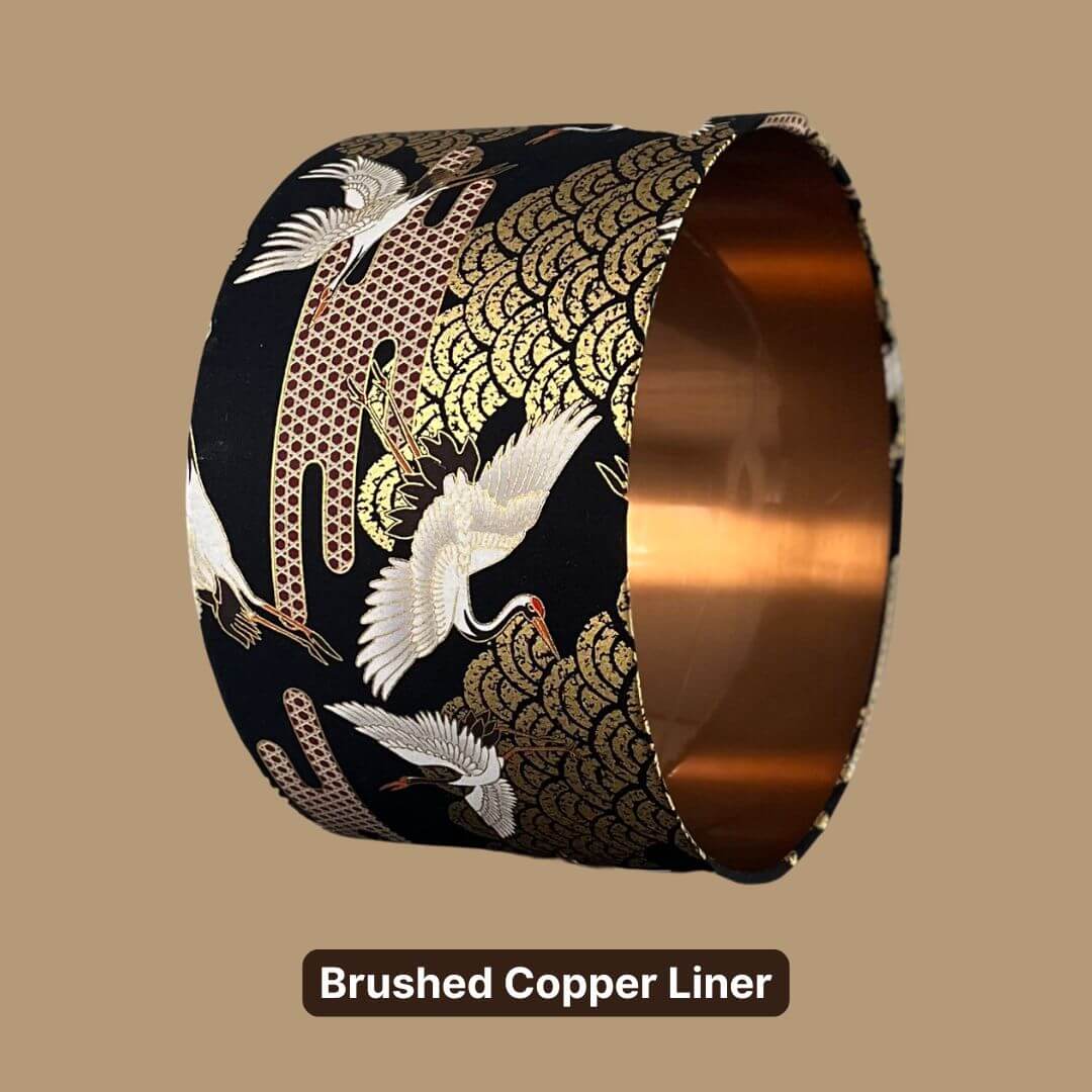 Japanese Cranes Lampshade, with cranes in flight and Art Deco-style clouds on a black background with gold metallic accents and a copper liner