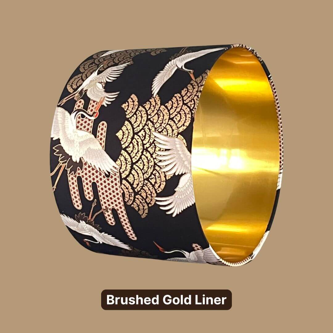 Japanese Cranes Lampshade, with cranes in flight and Art Deco-style clouds on a black background with gold metallic accents and a gold liner