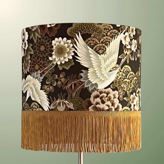 Stunning drum lampshade featuring an authentic Japanese fabric and a gold finge. beautiful cranes paired with florals and metallic accents in gold and bronze