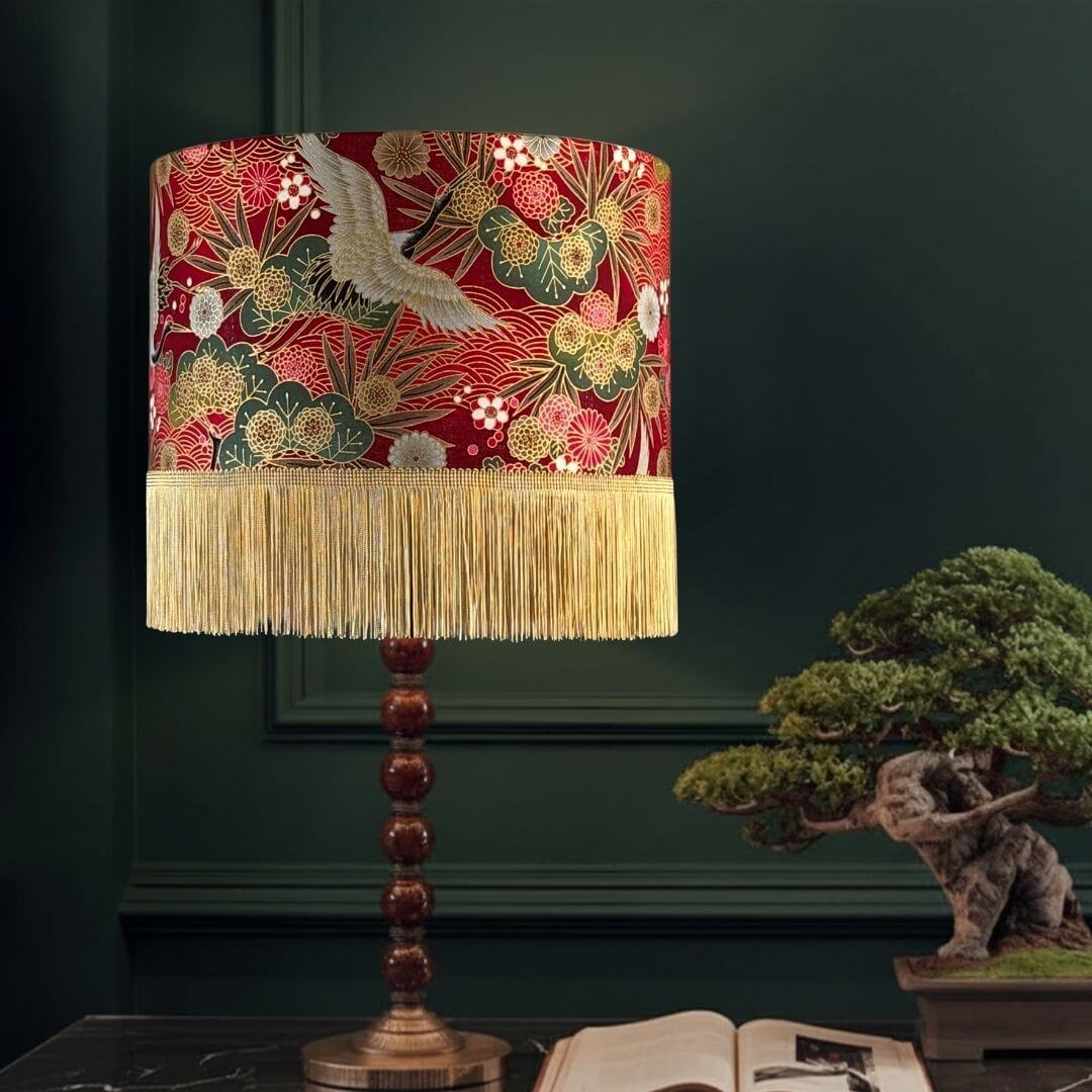 Drum Lampshade made with Authentic Japanese fabric with cranes, florals, metallic gold accents and gold fringe on lampstand in panelled room