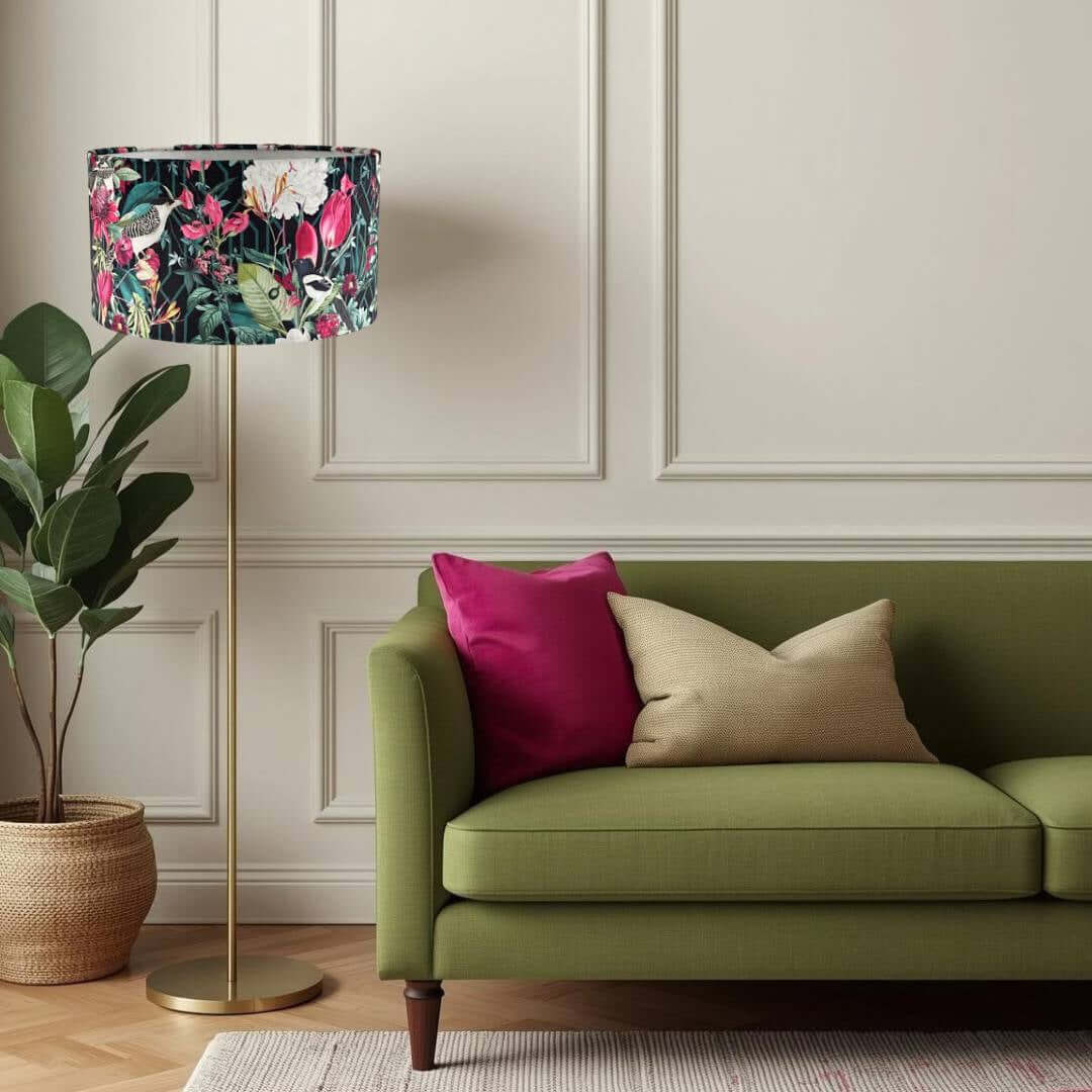 living room with sofe and lamp with bright jungle pattern