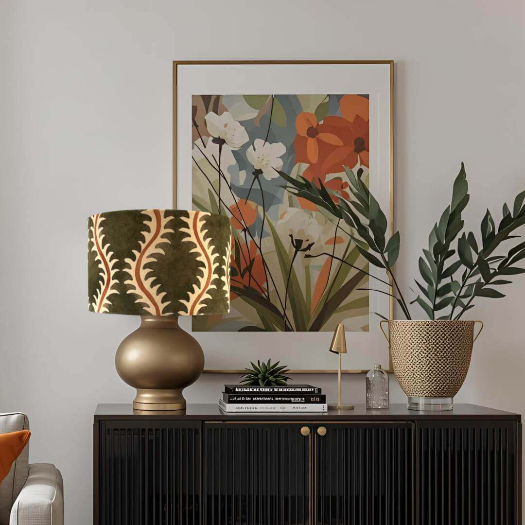 Decorative setup with a lamp, plant, and framed artwork on a console table.