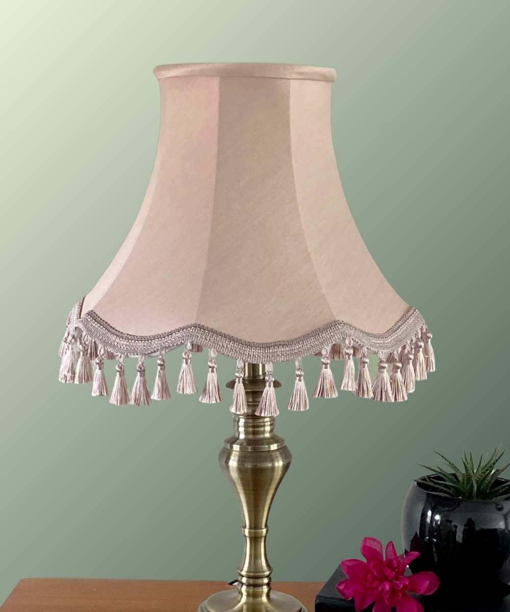 Pink lampshade on scallop frame with tassel trim