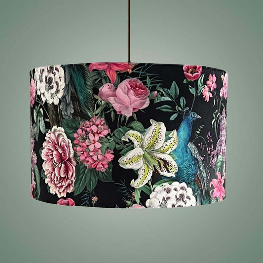 Velvet drum lampshade on a pendant in a Romantic design with peacocks and lush floral blossoms on a black background