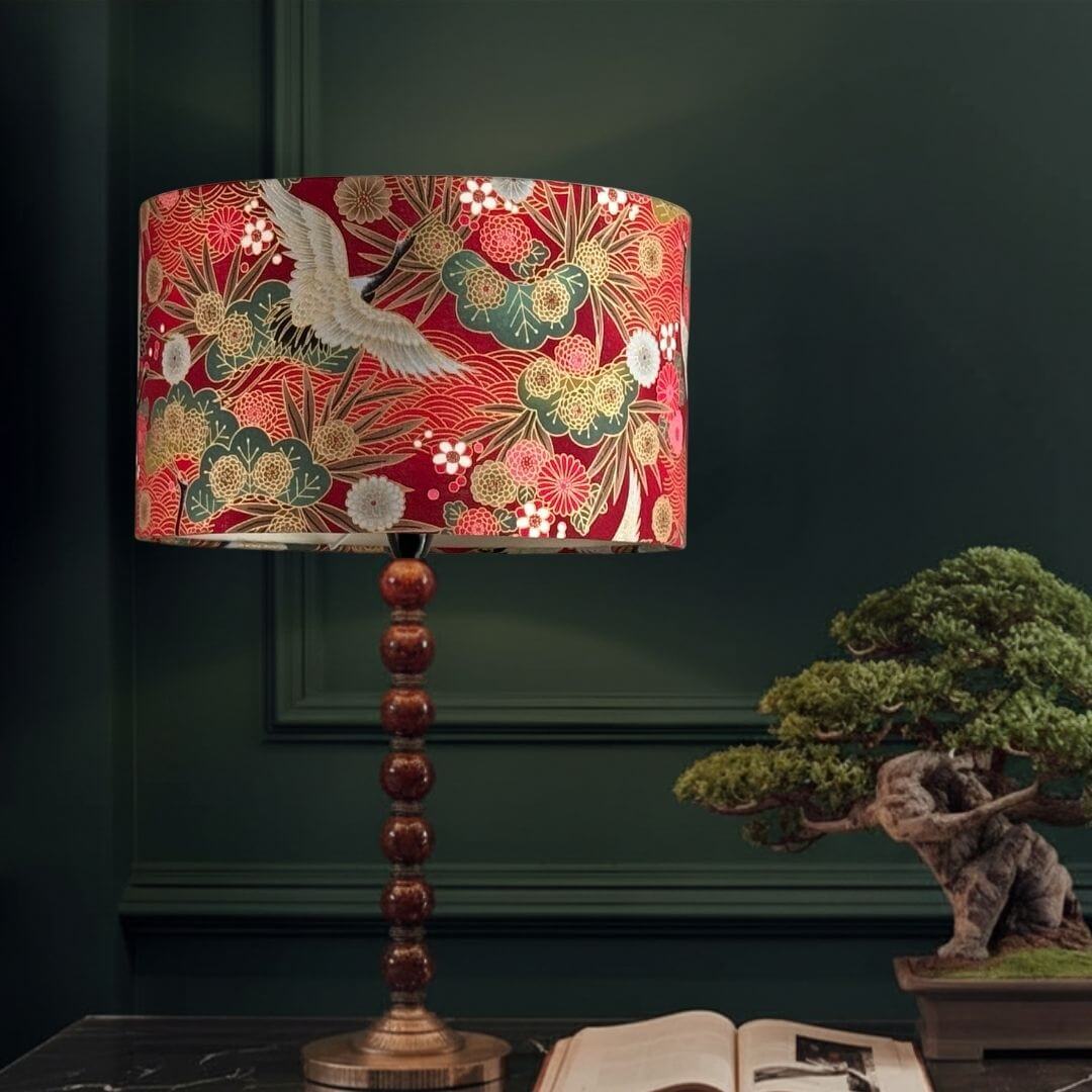Drum Lampshade made with Authetic Japanese fabric with cranes, florals and metalic gold accents on table with bonsai 