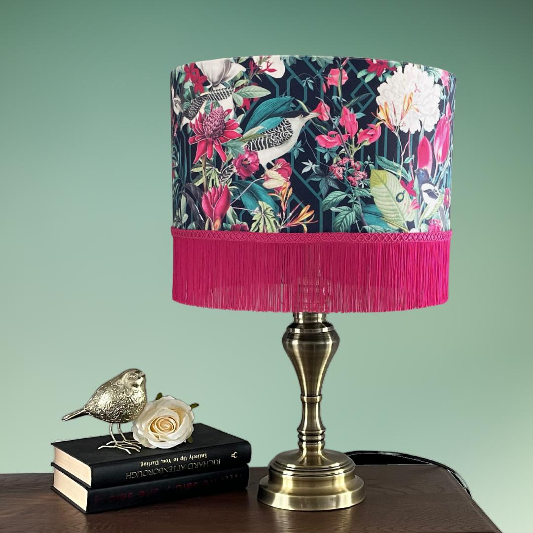 Jungle birds and florals lampshade with hot pink fringe on lamp stand 