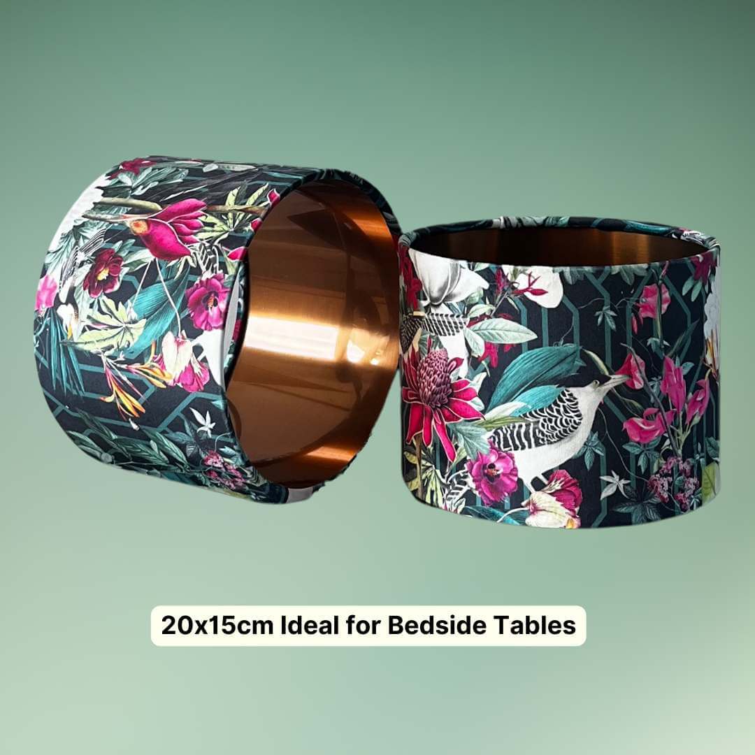 Pair of small bedside drum lampshades with Bold jungle fabric featuring birds, florals and botanicals and a copper inner