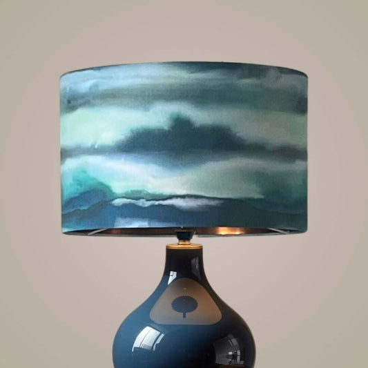 Voyage Maison Fjord Cobalt Drum lampshade on a blue table lamp