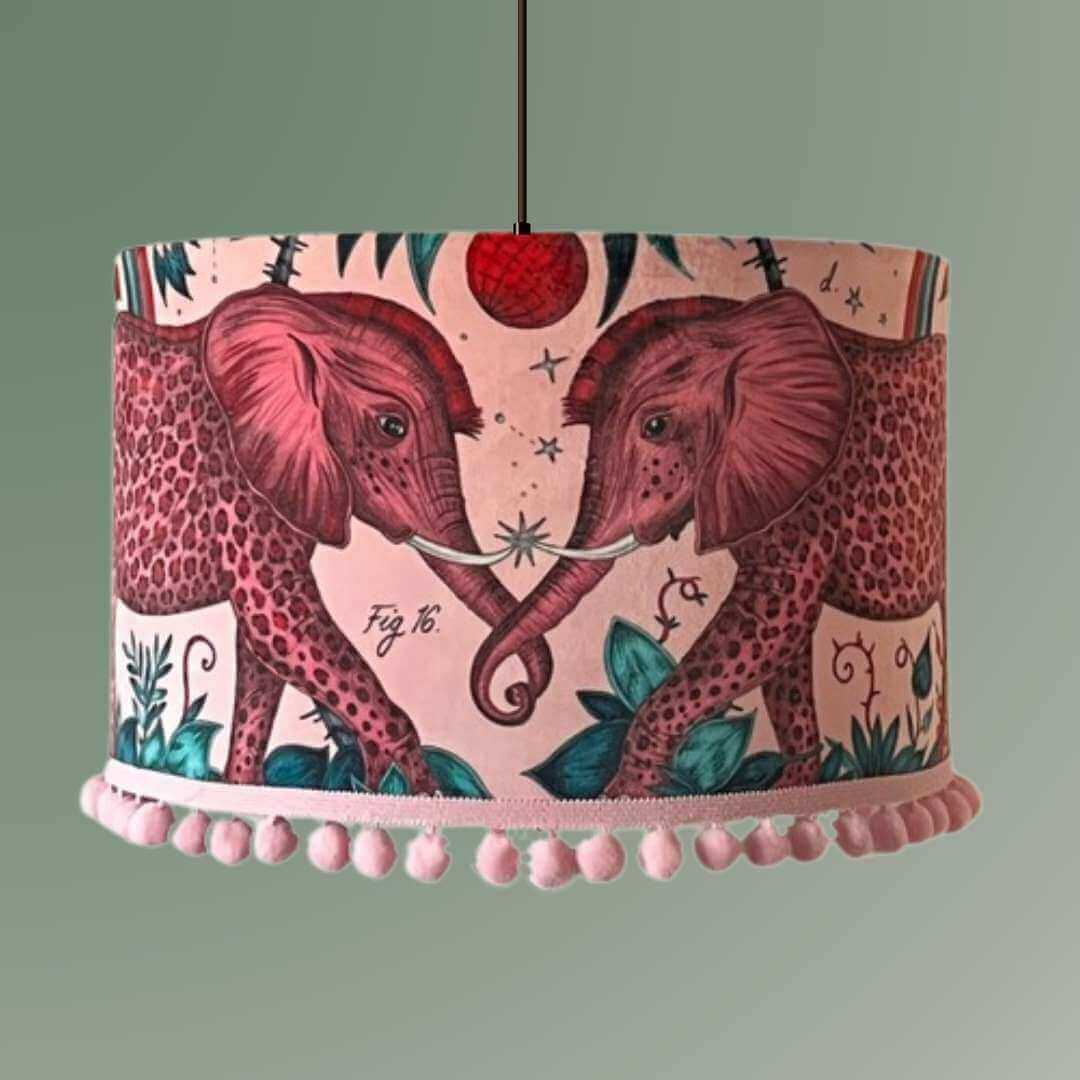 Emma Shipley zambezi design Lampshade with elephants and jungle foliage on a pink velvet background with pom pom trim