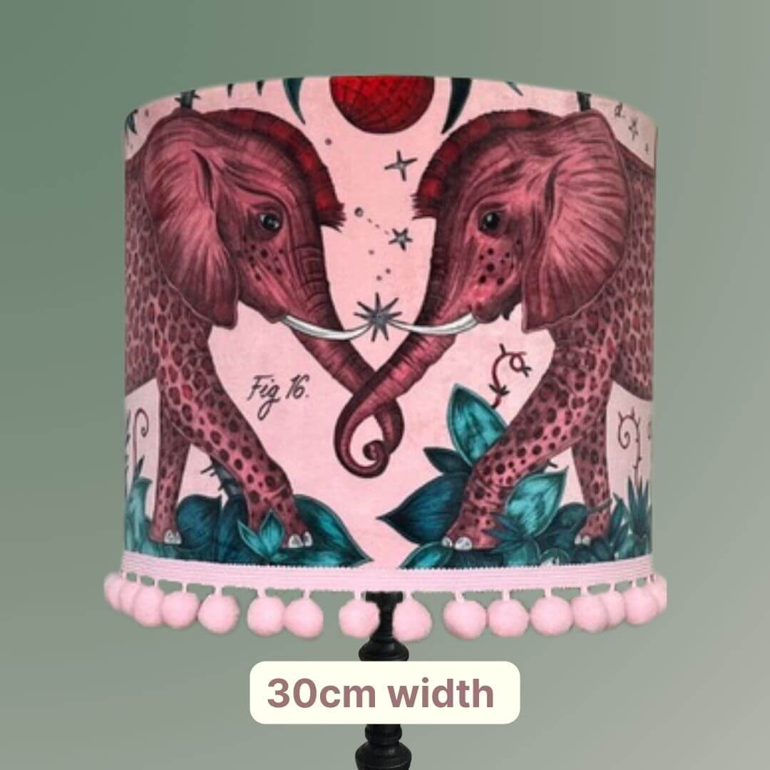 Emma Shipley zambezi design Lampshade with elephants and jungle foliage on a pink velvet background with pom pom trim