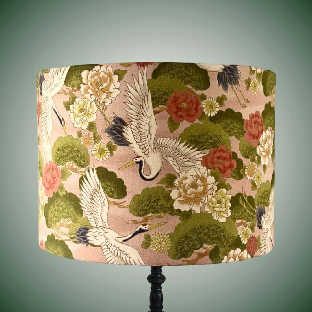 Decorative lampshade with Japanese crane and floral pattern on a peachy pink background 