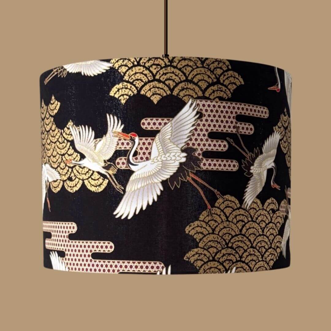 Japanese Cranes Lampshade, with cranes in flight and Art Deco-style clouds on a black background with gold metallic accents 
